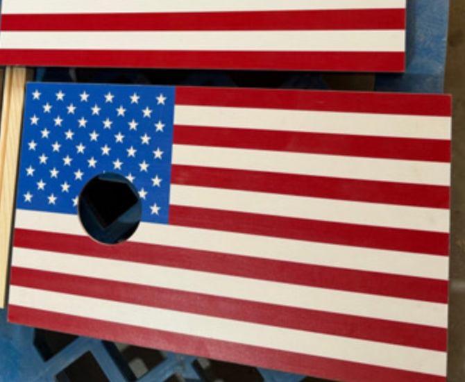 Close-up of laser engraved logo on acacia wood coaster at Chic Homeware factory